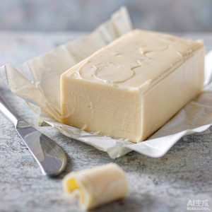 Cultured butter block with knife on stone